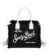 T11411 - Bolso bandolera y de mano para la playa con flecos y con letras bordadas